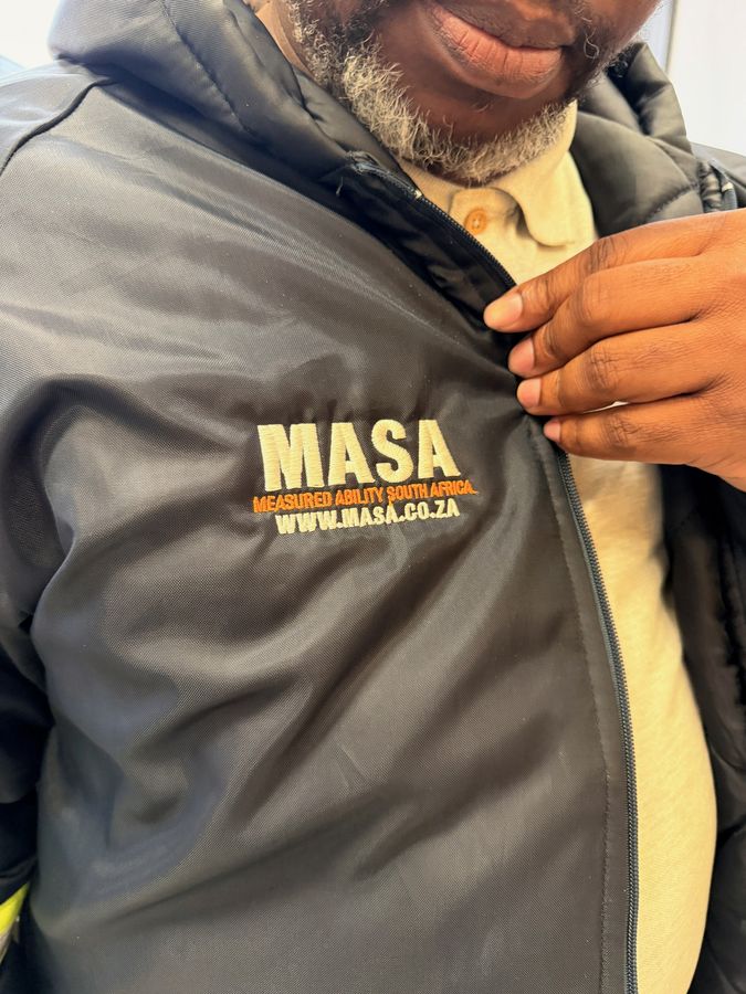 A padded workwear jacket with an embroidered chest logo