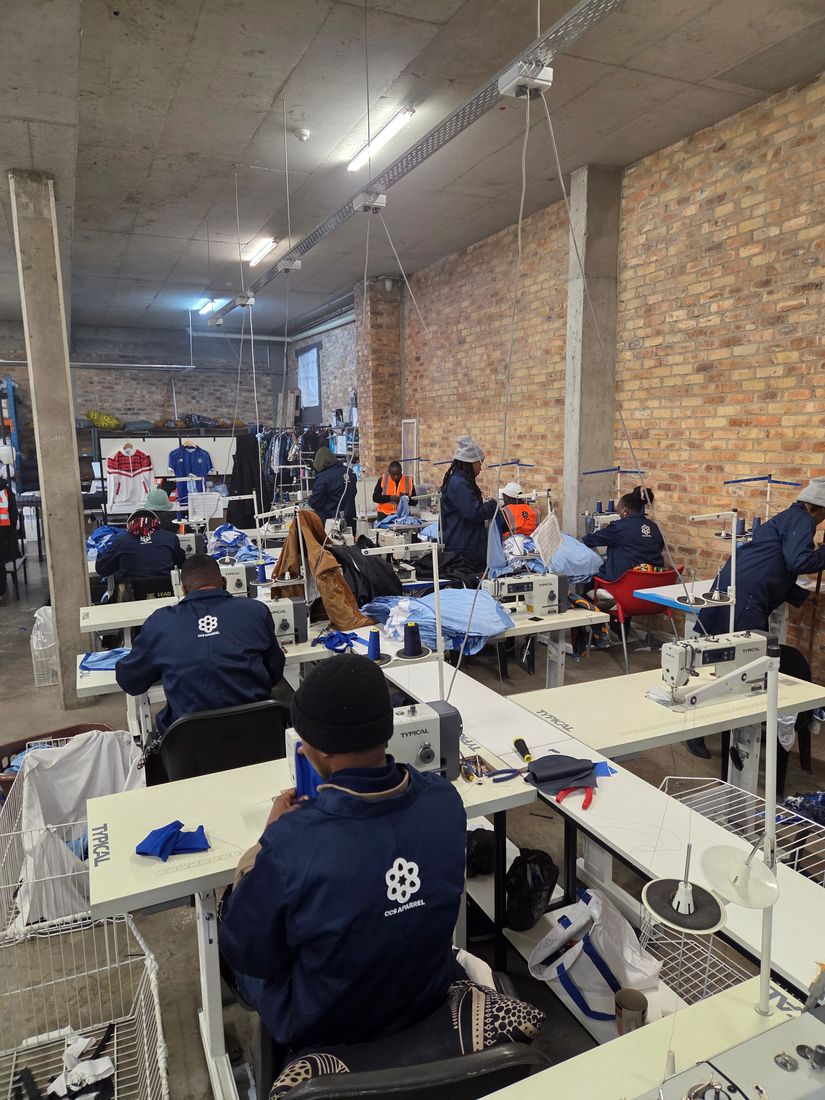 Machinists in CCS coats at their sewing stations