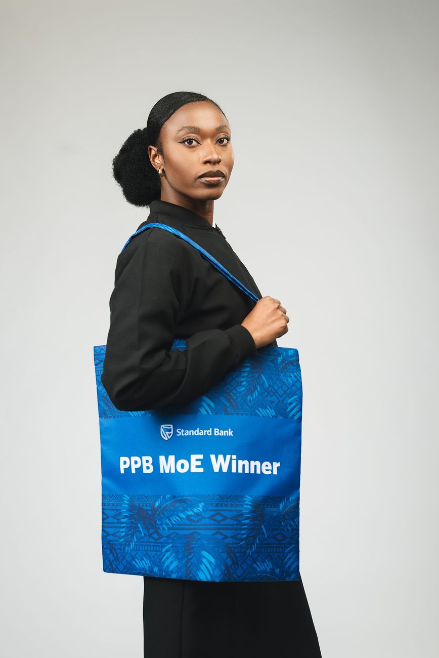 A woman carrying a blue printed tote bag
